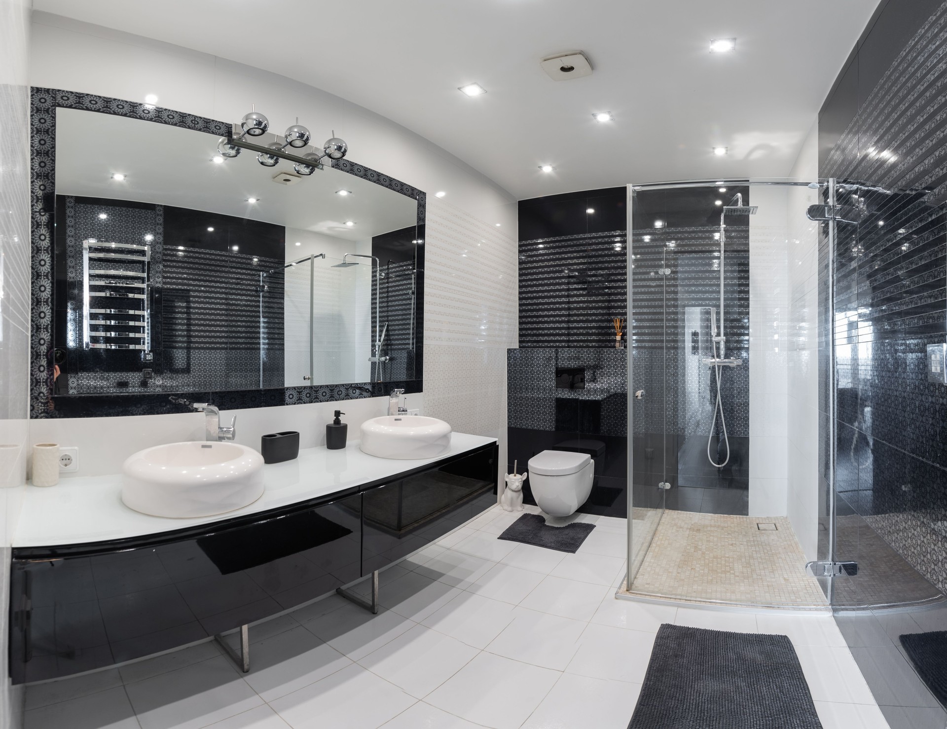 Modern Bathroom Design with Glass Shower and Stylish Black and White Details. A spacious and contemporary bathroom featuring a glass shower, chic black and white decor, and sleek fixtures.